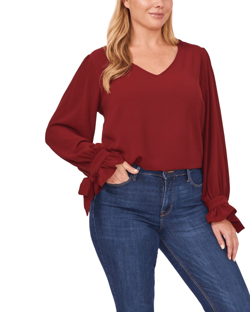 Front of a model wearing a size 1X Isla Tie-Sleeve Blouse in 637-Claret Red by CeCe. | dia_product_style_image_id:263933